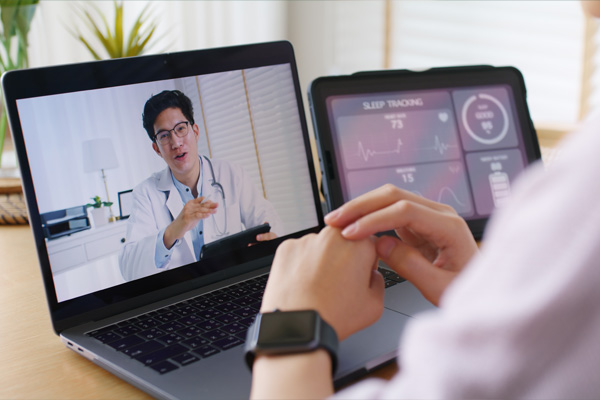 Patient speaking with a doctor via telehealth call on a laptop