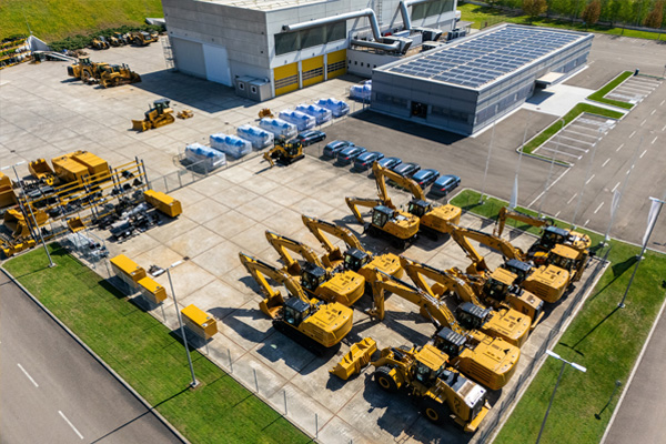 Aerial view of heavy machinery and tractors at a manufacturing facility