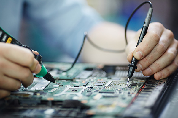 Image of a technician running tests on a new electronic device
