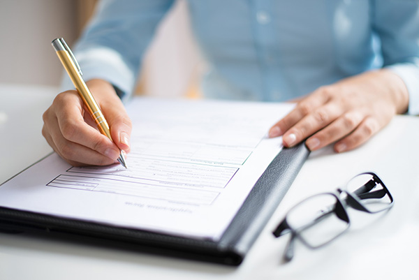 Image of an electronics engineer reviewing compliance test reports for a product