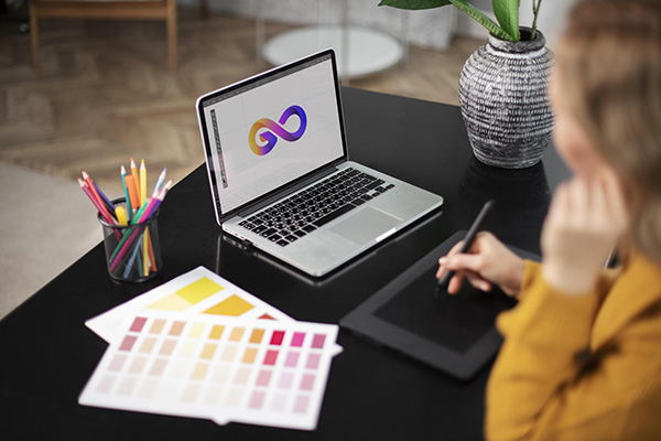 Image of a designer working on a marketing graphic for a product launch, using a high-resolution laptop
