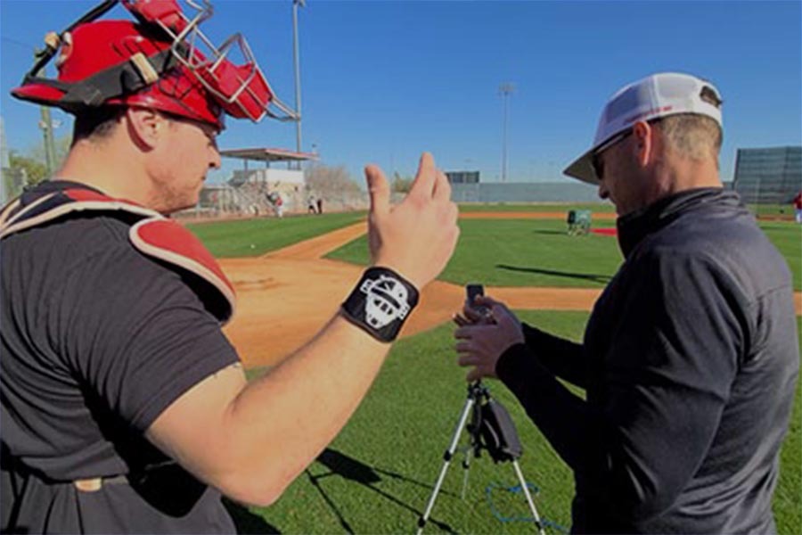Baseball players using Caught Stealing Pro100 training equipment on a field