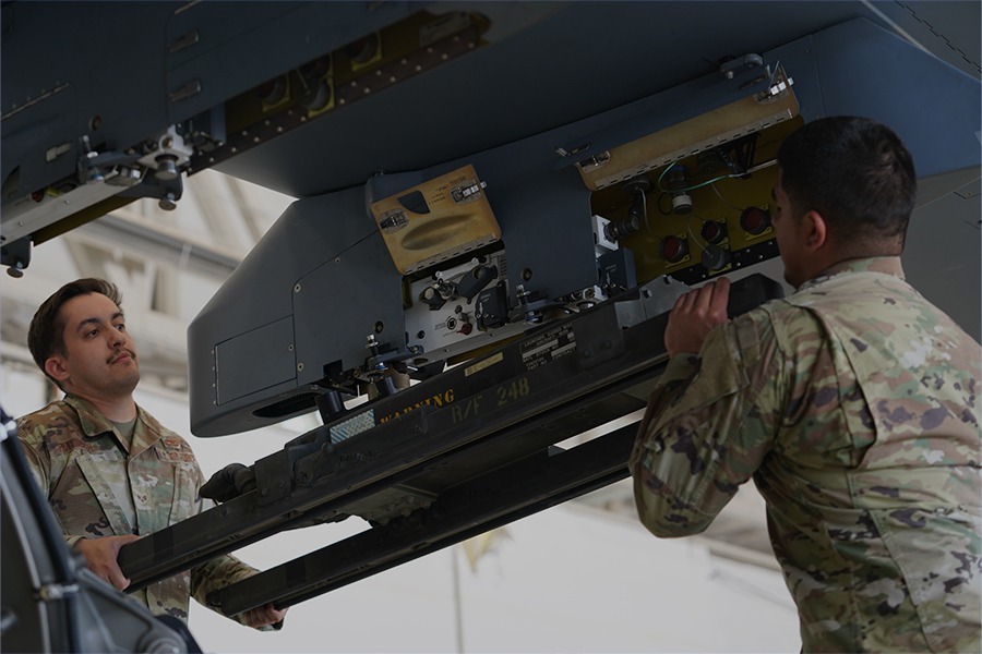 Military personnel integrating mission payload electronics on an unmanned aircraft